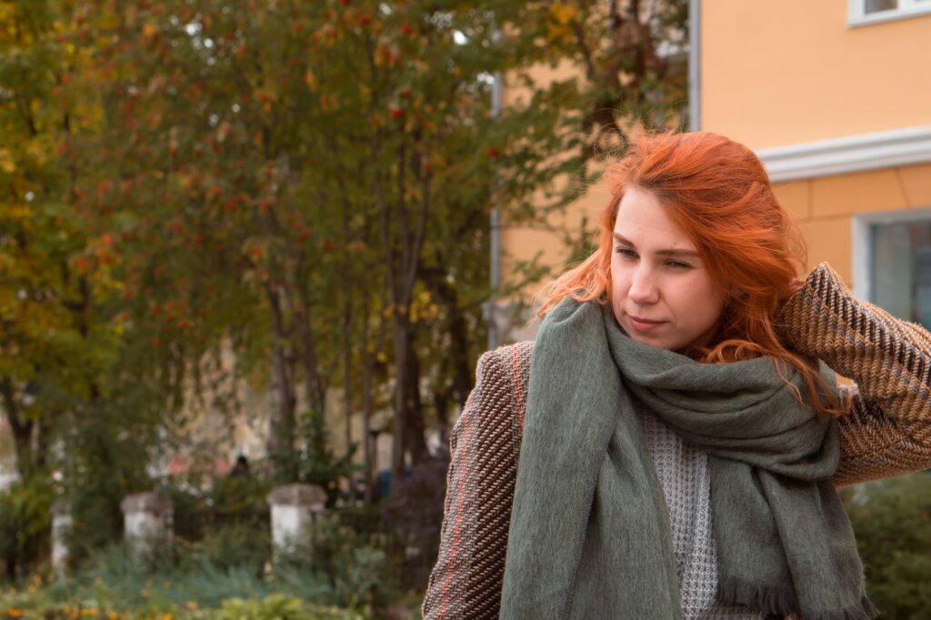 worried young woman outdoors in city