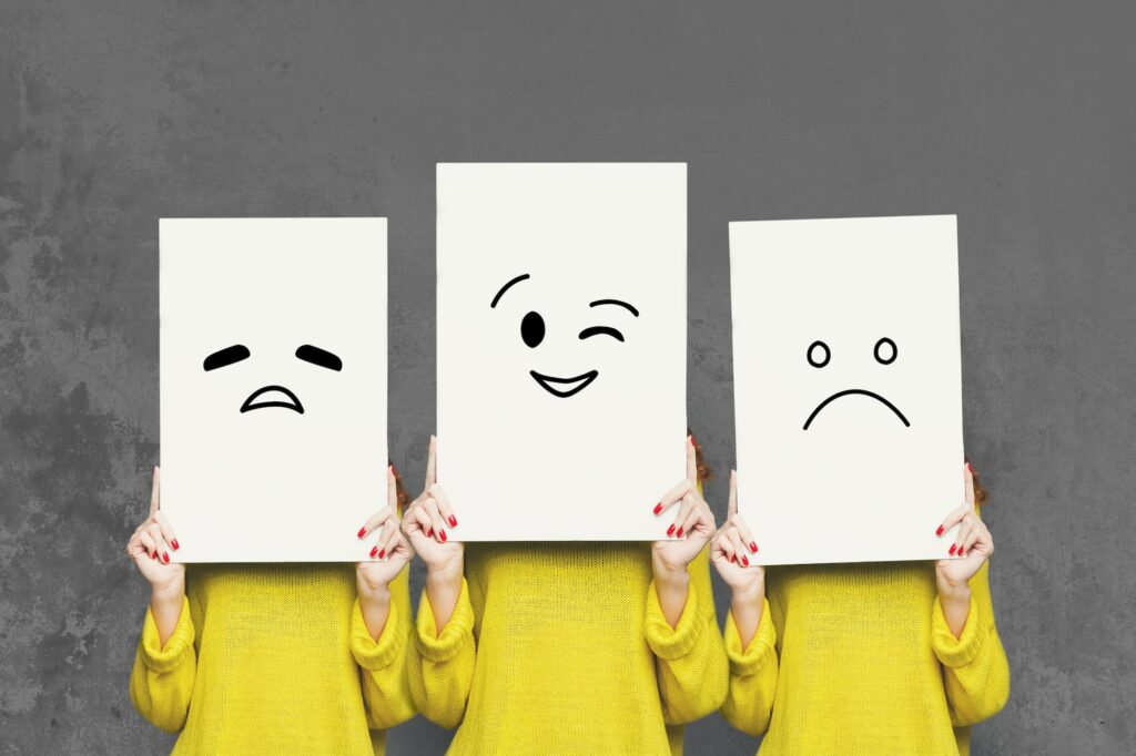 Girl covering face with white boards. Set of painted emotions