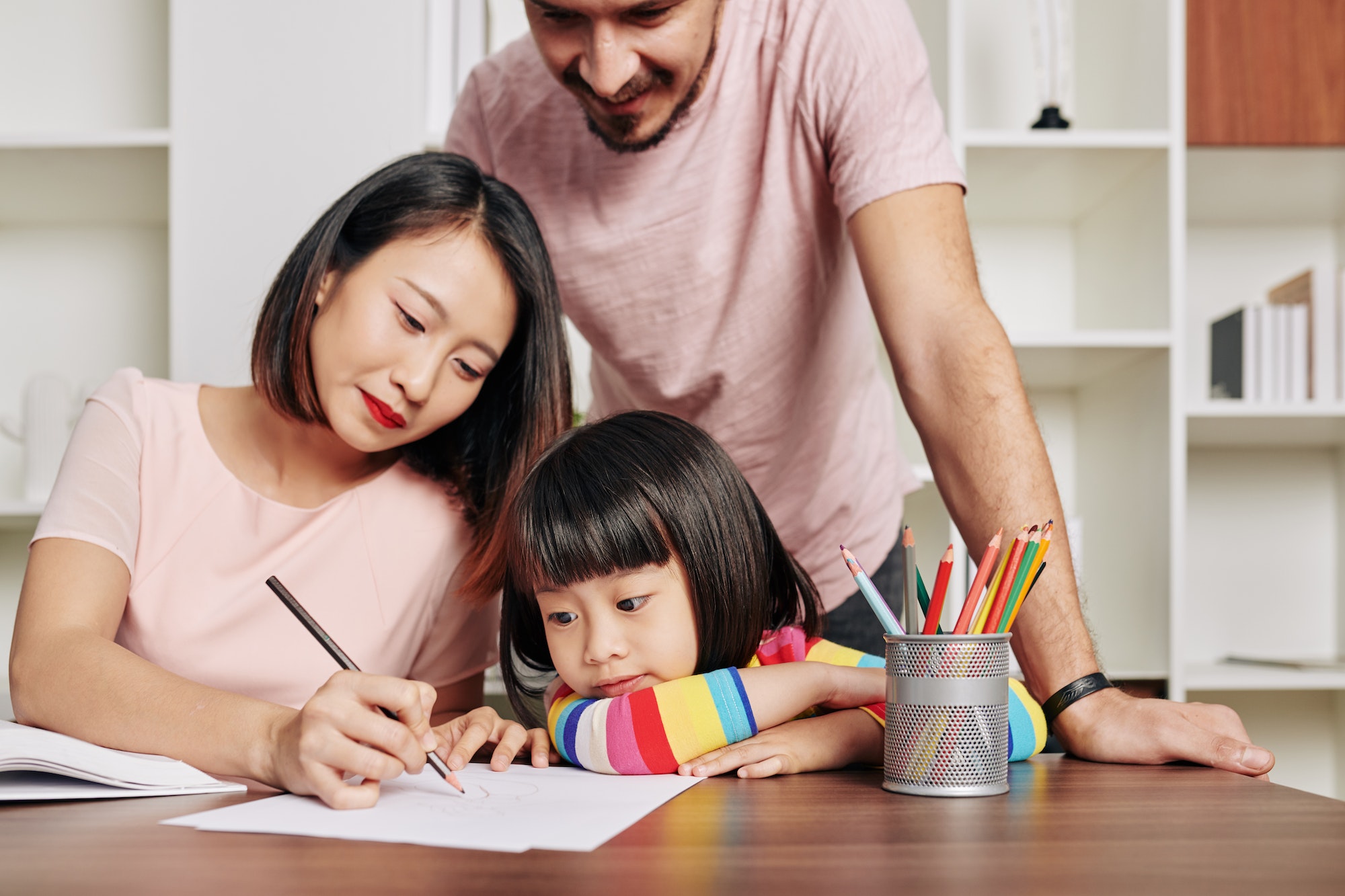 Parents teaching daughter