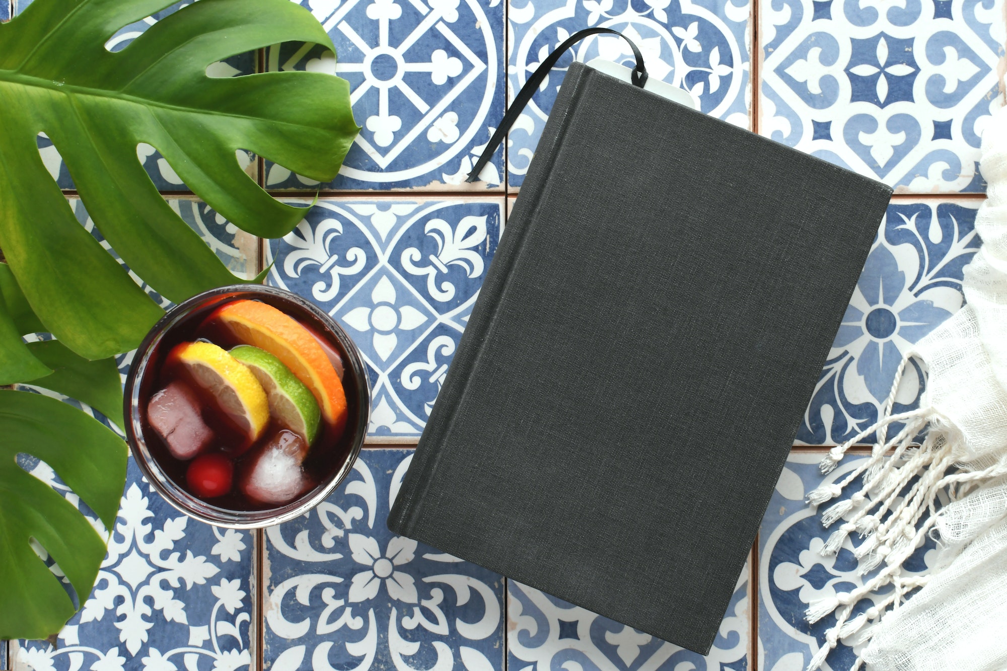 Blank book cover for mock up on mosaic tiles with sangria for exotic travel vibe, background